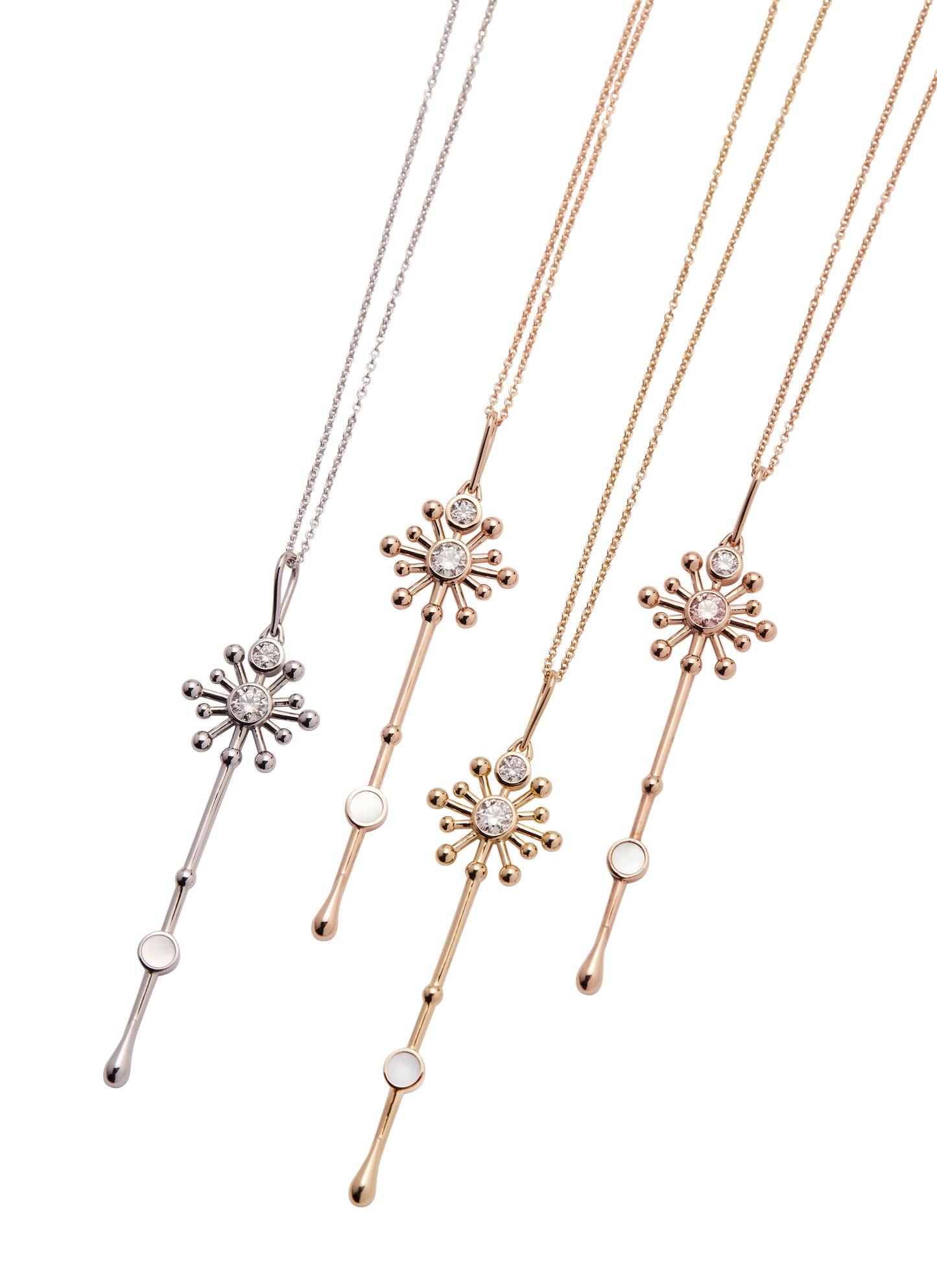 Four Light Wand pendants in 18K gold with mother-of-pearl displayed together