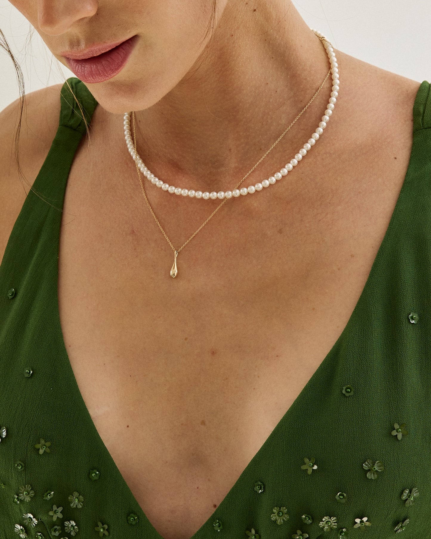 Roseate WaterDrop small pendant in 14k yellow gold with mother-of-pearl worn on a model