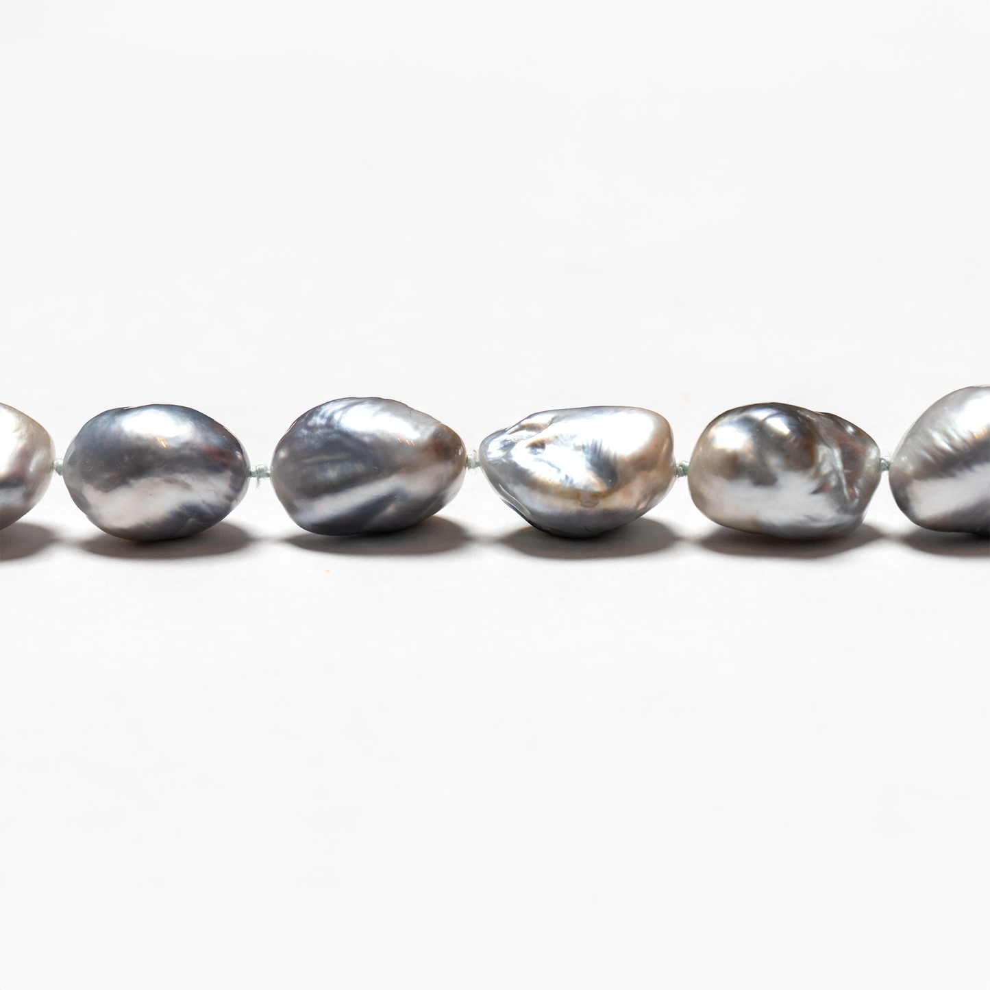 Close up of Tahitian baroque light grey pearl strand