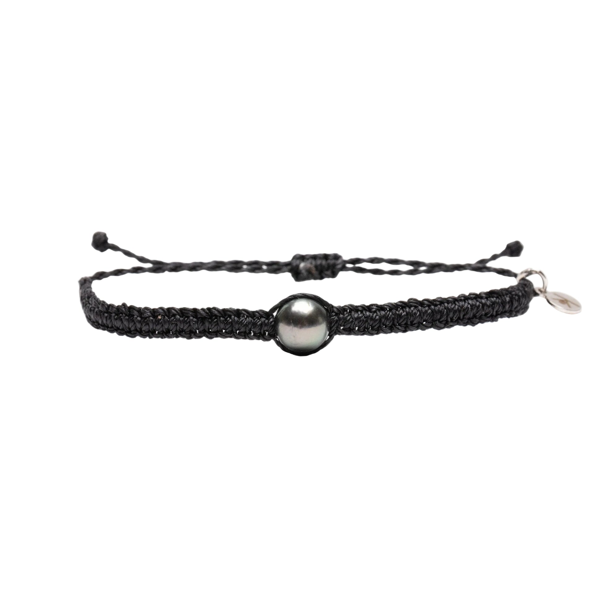 Black braided bracelet with a Tahitian pearl on a white background
