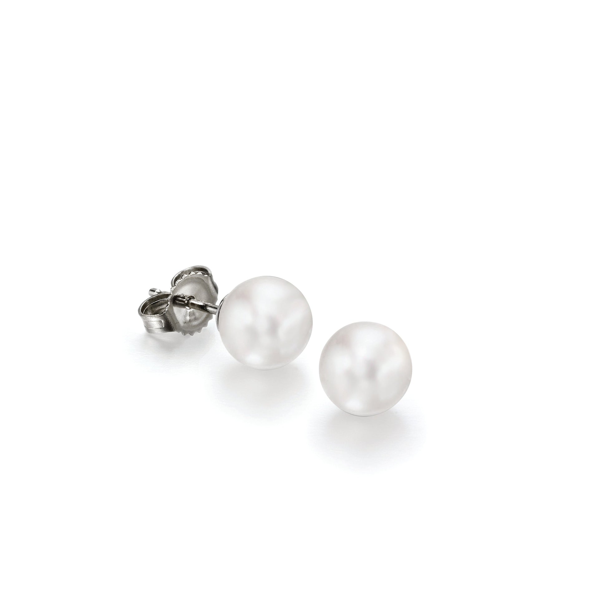 Pair of pearl stud earrings on a white background