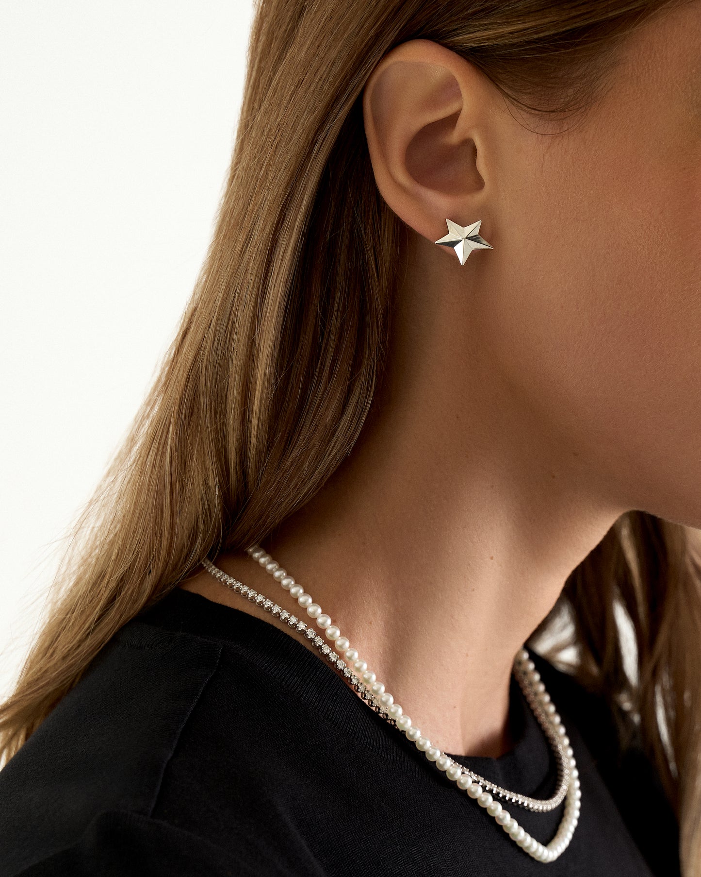 Angela Cummings small sterling silver star earrings on model
