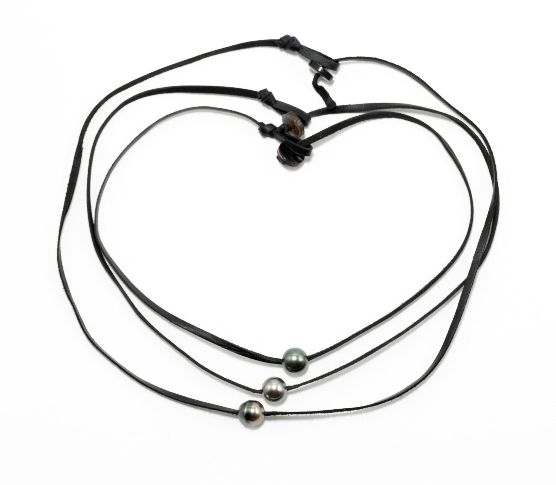 Three Tahitian pearl necklaces on leather cords in a group shot