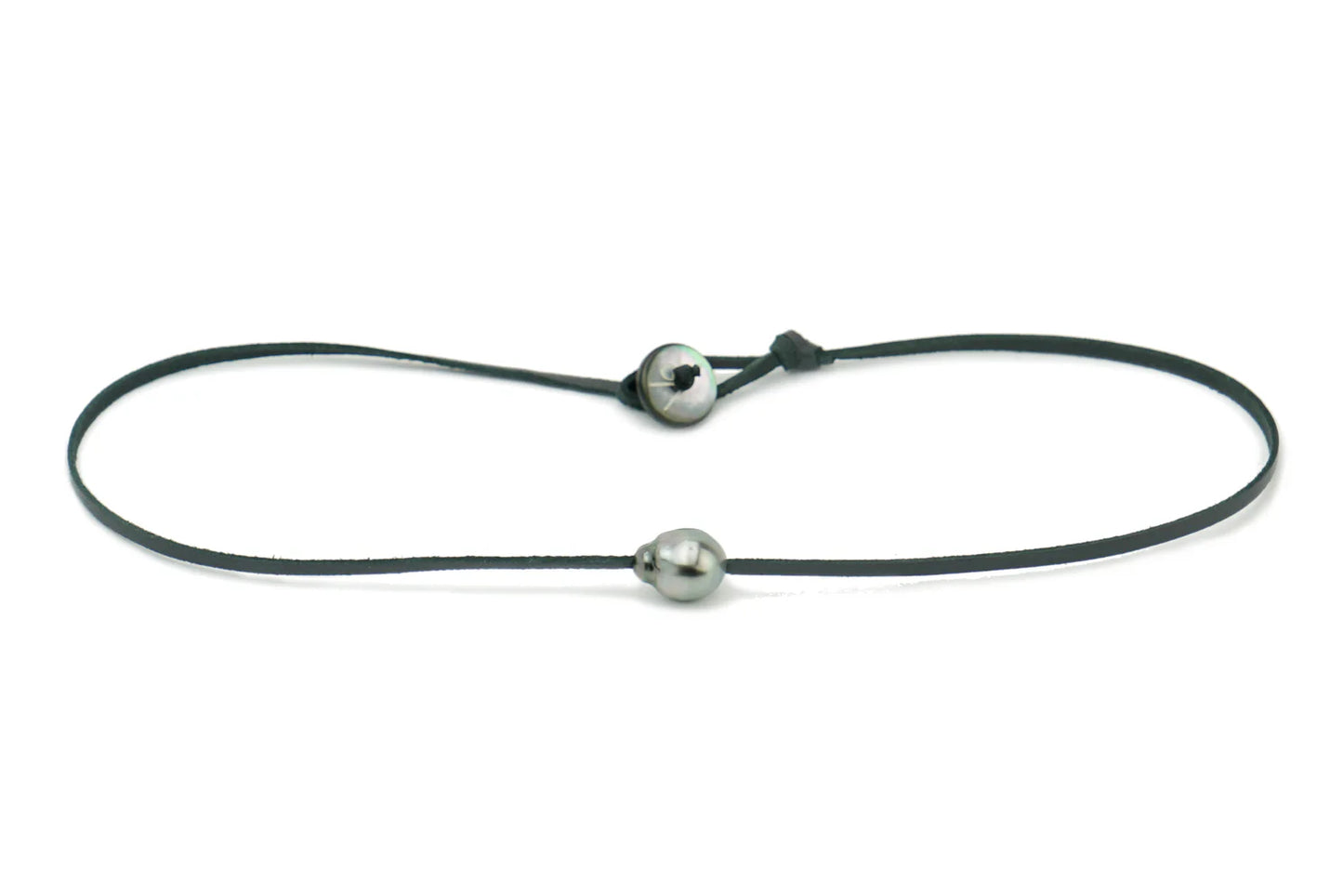 A black leather cord necklace with a silver-colored mother-of-pearl button closure and a Tahitian pearl.