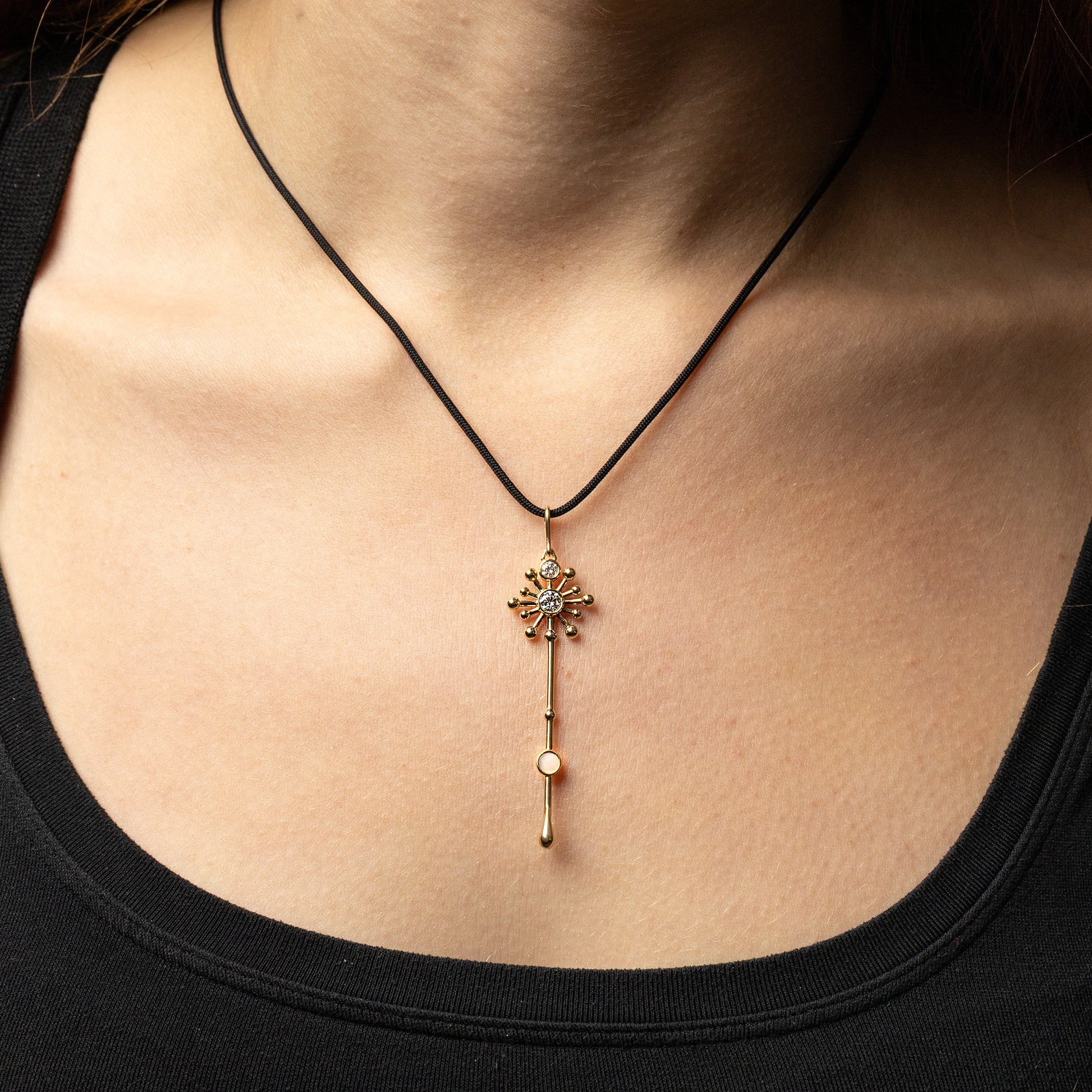 Light Wand Pendant in 18K yellow gold with luminous mother-of-pearl worn on a model