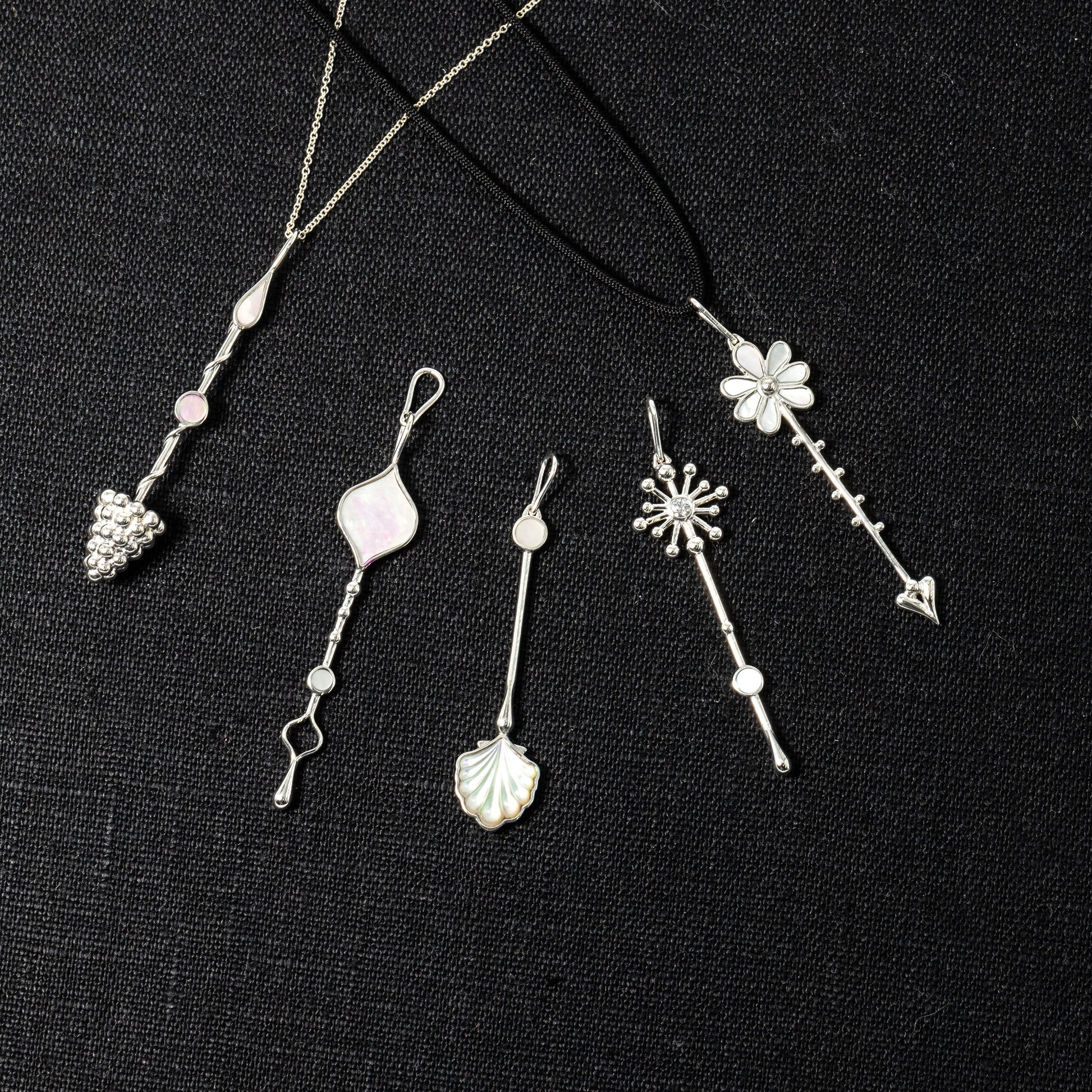 Multiple Wand pendants in sterling silver with mother-of-pearl displayed together