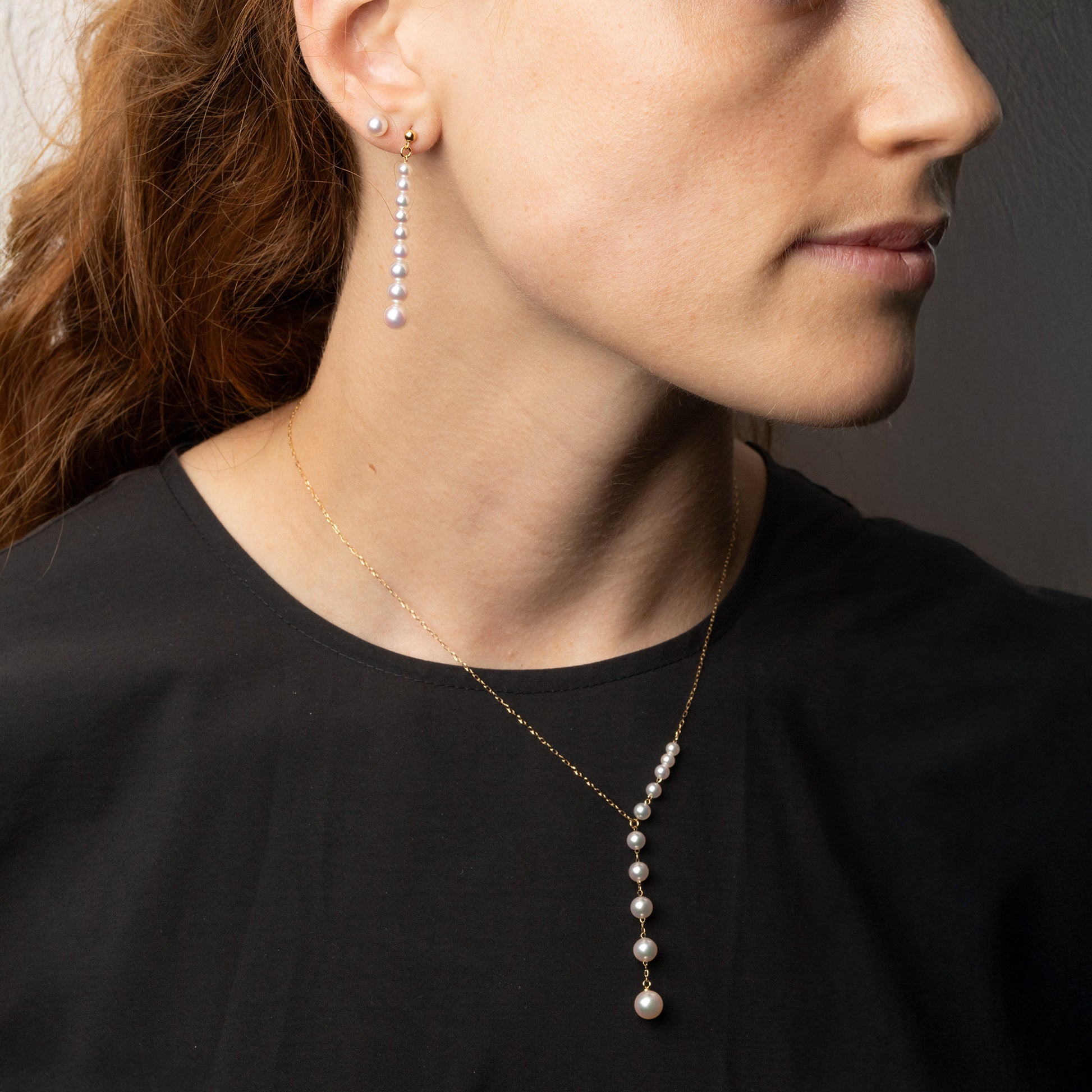 Graduated Akoya cultured pearl Y-necklace in 18K yellow gold featuring luminous white Akoya pearls that increase in size along a delicate gold chain, creating a modern feminine silhouette. Shown on model.