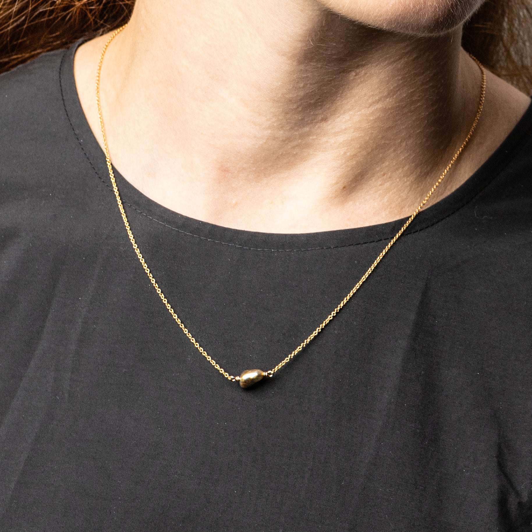 Natural keshi pearl pendant necklace on a solid 18k rose gold chain by Roseate Jewelry, worn on model.