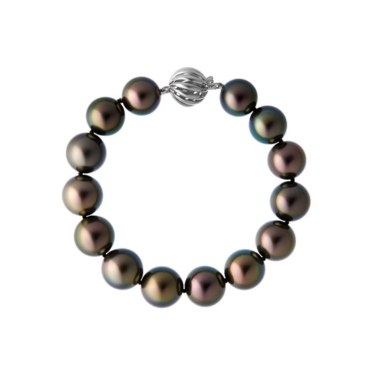 The Odyssey | Roseate Moons 12mm round Tahitian pearl bracelet with an 18k white gold swirl clasp.