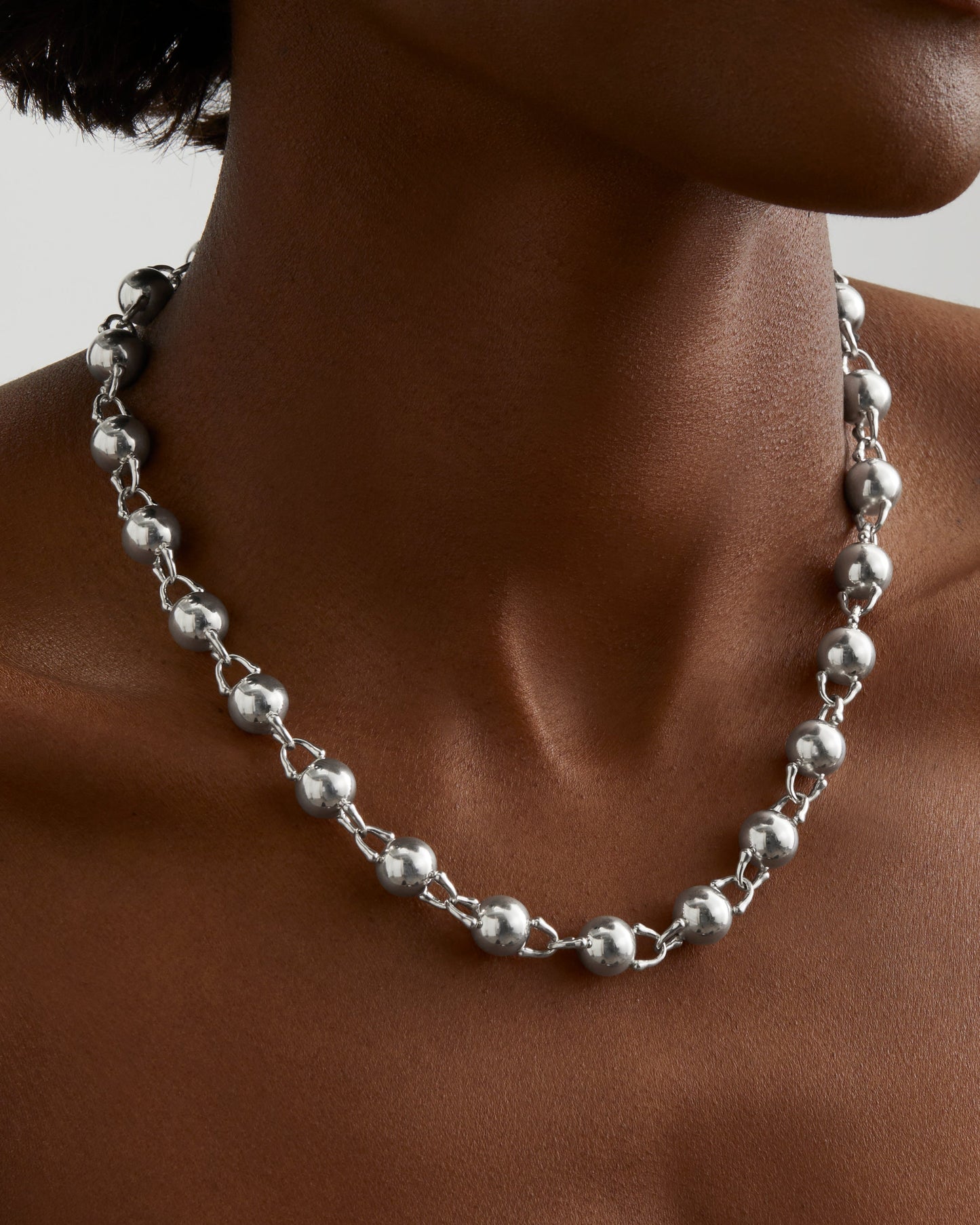 Roseate TreasureLock 10mm bead necklace in sterling silver worn on a model