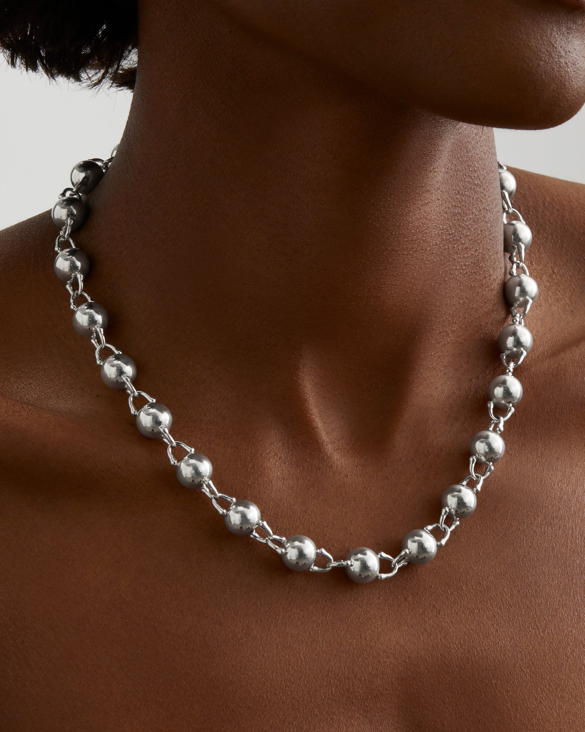 Roseate TreasureLock 10mm bead necklace in sterling silver worn on a model