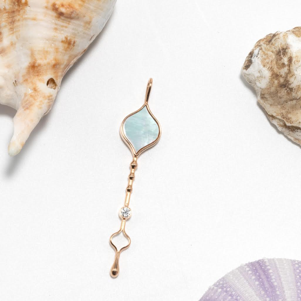 Roseate Unity Wand pendant in 18k rose gold with mother-of-pearl styled in context