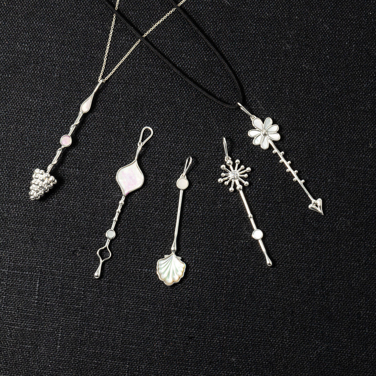 Five sterling silver Roseate Wand pendants shown together
