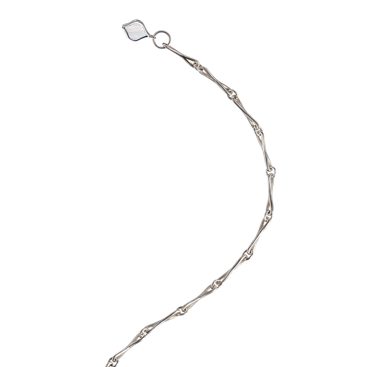 Close detail of the mother-of-pearl tag on the Roseate WaterDrop small link bracelet in sterling silver