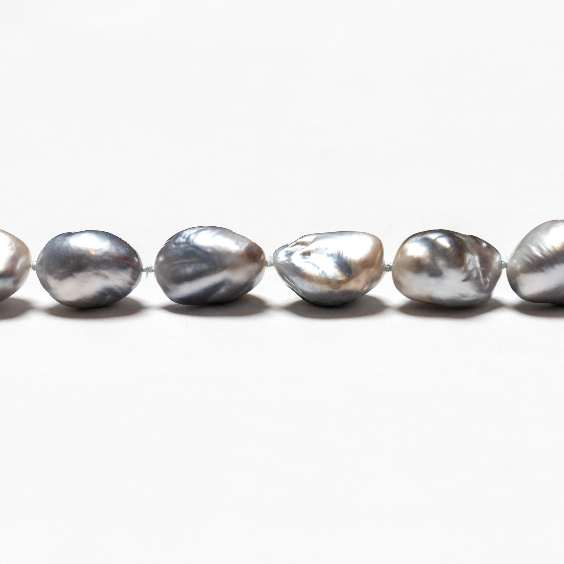 Close up of Tahitian baroque light grey pearl strand