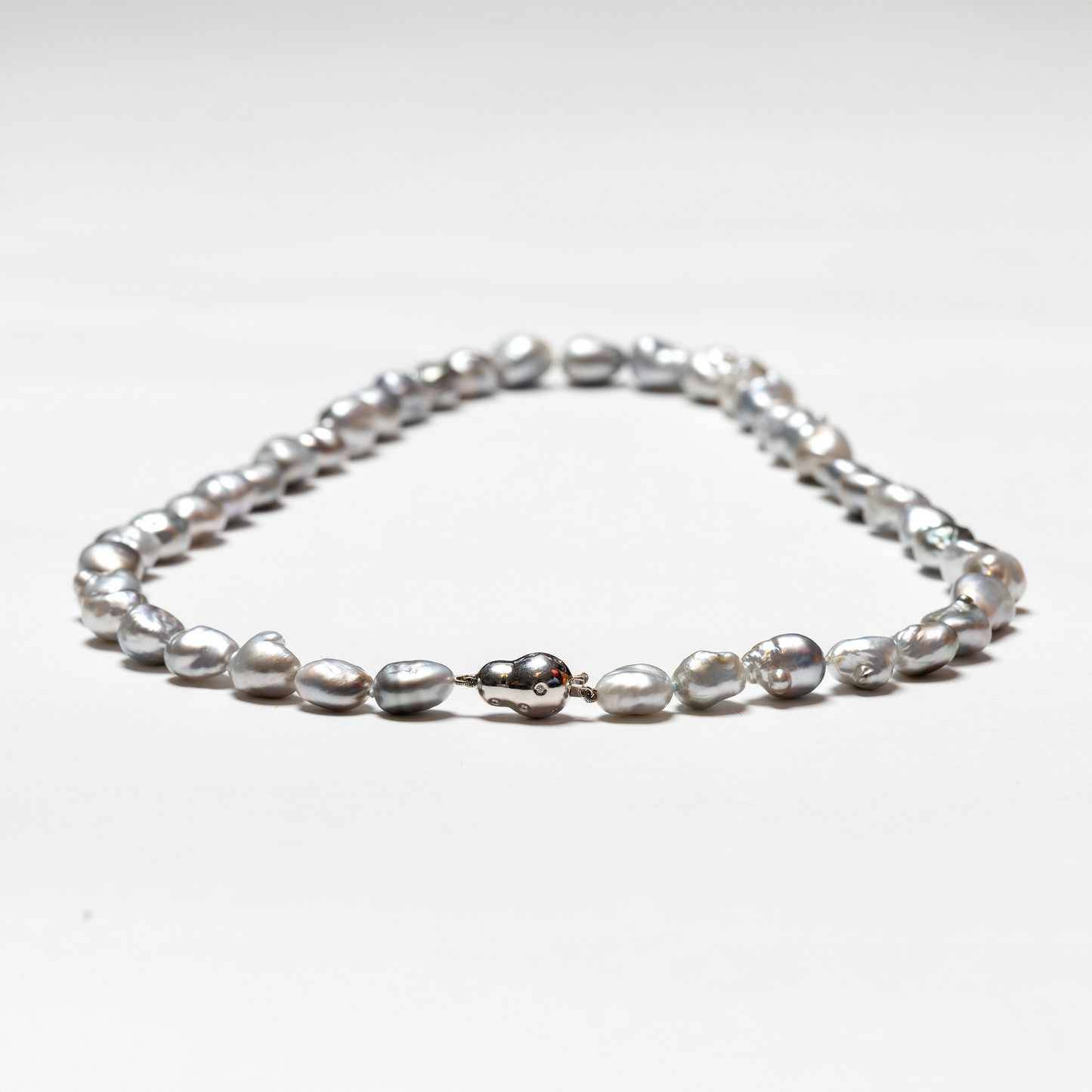 Tahitian baroque pearl strand highlighting white gold and diamond bean clasp 