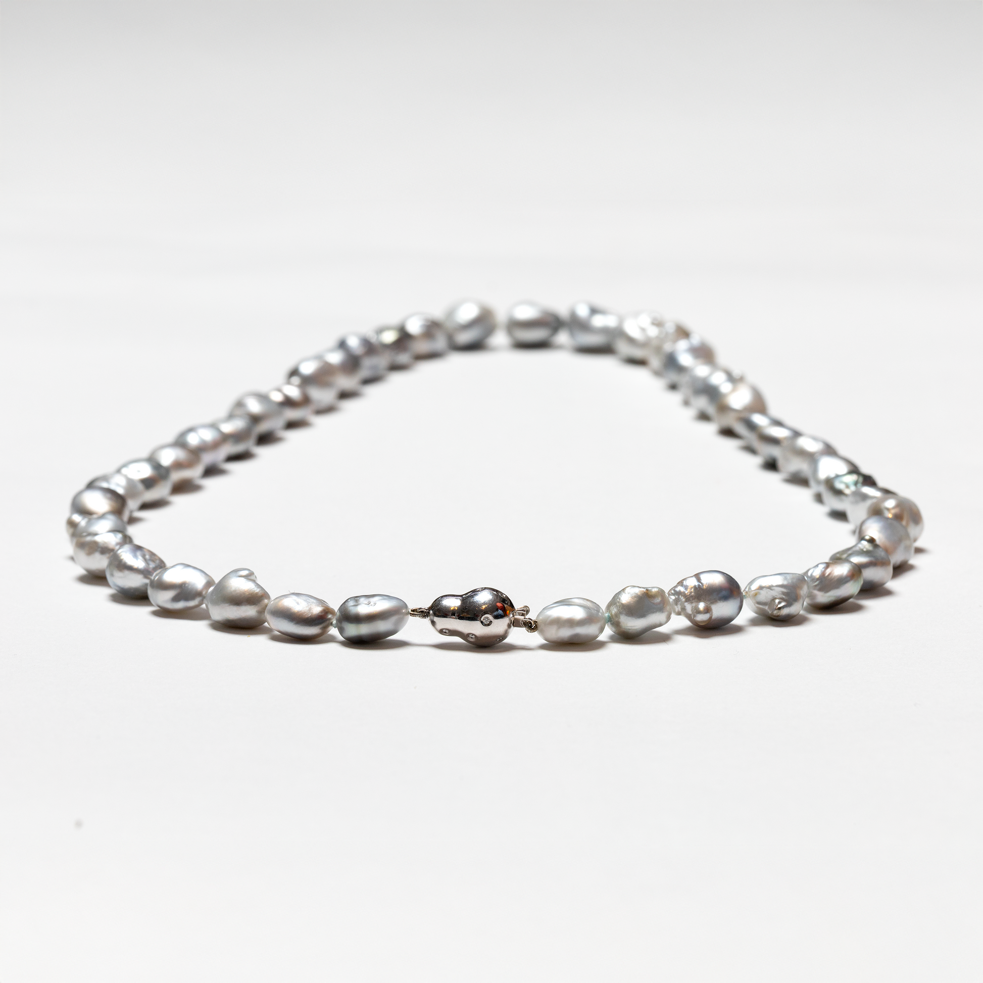 Tahitian baroque pearl strand highlighting white gold and diamond bean clasp 