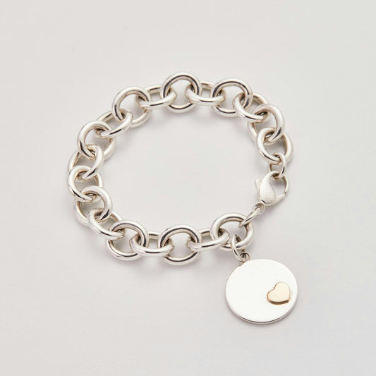 Tiary Empower Your Heart bracelet in sterling silver featuring a polished 22mm round charm with a solid 14K yellow gold heart accent.