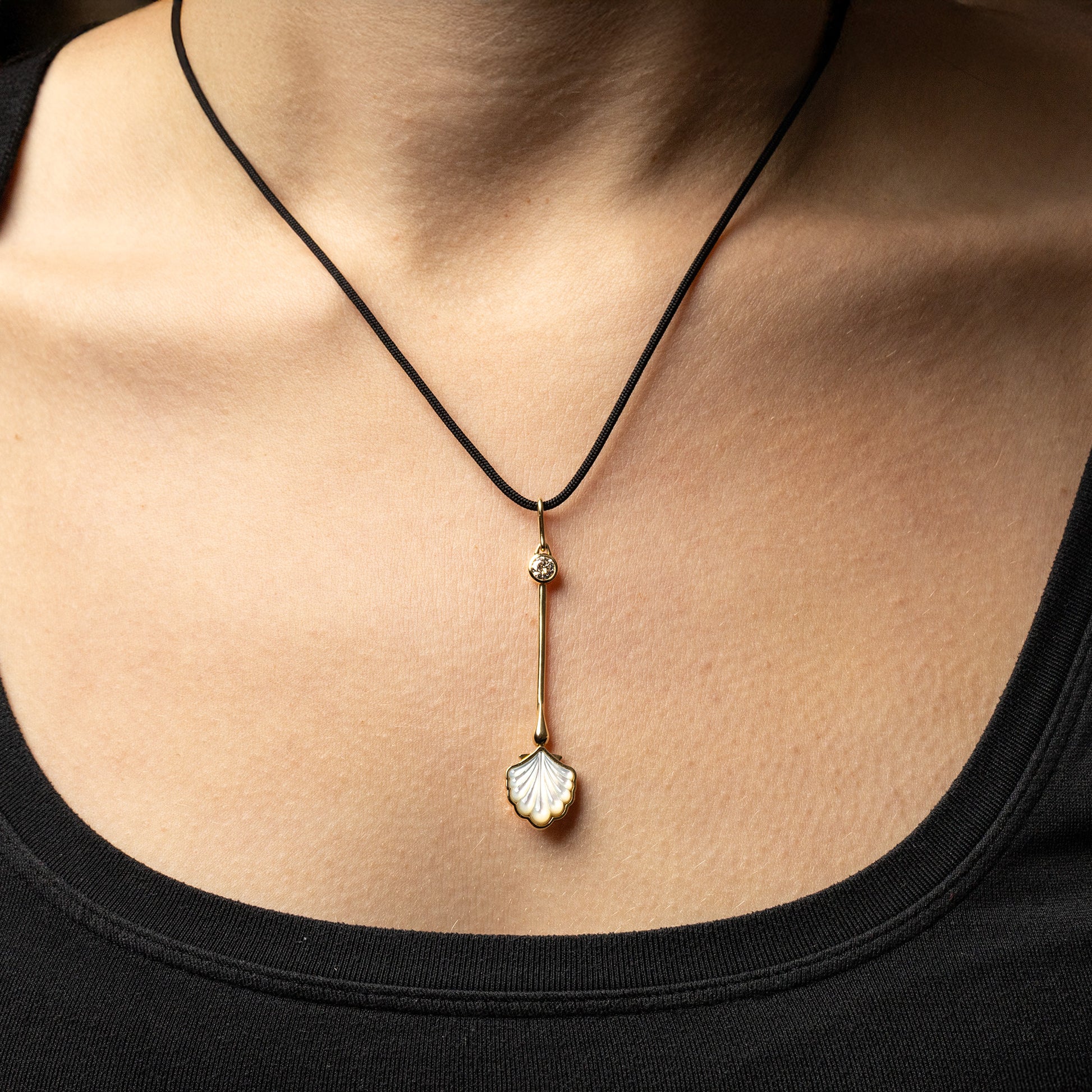 Water Wand Pendant in 18K rose gold with luminous mother-of-pearl worn on a silk cord