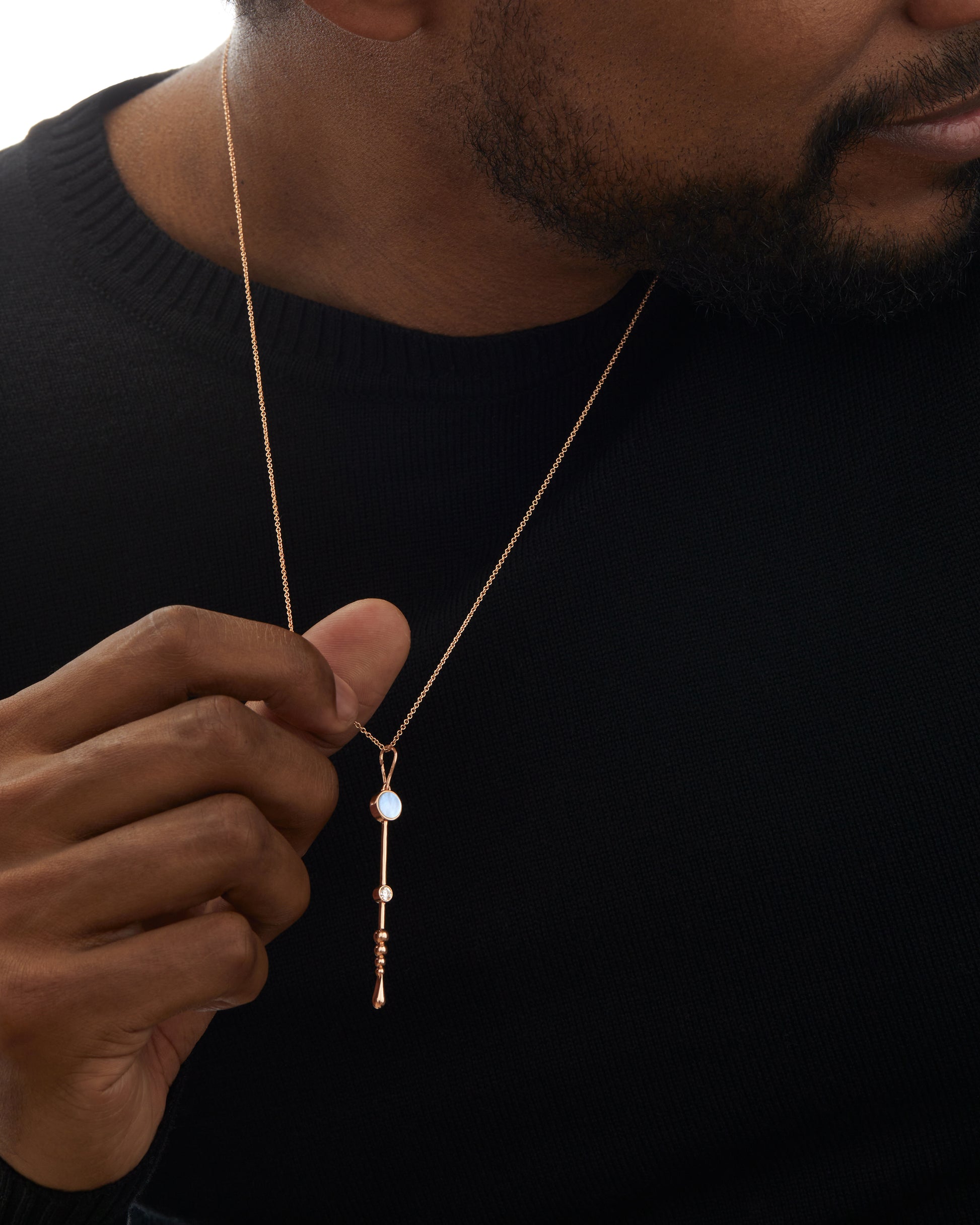 Loyalty Wand Pendant in 18K rose gold with luminous mother-of-pearl and a diamond worn by a model