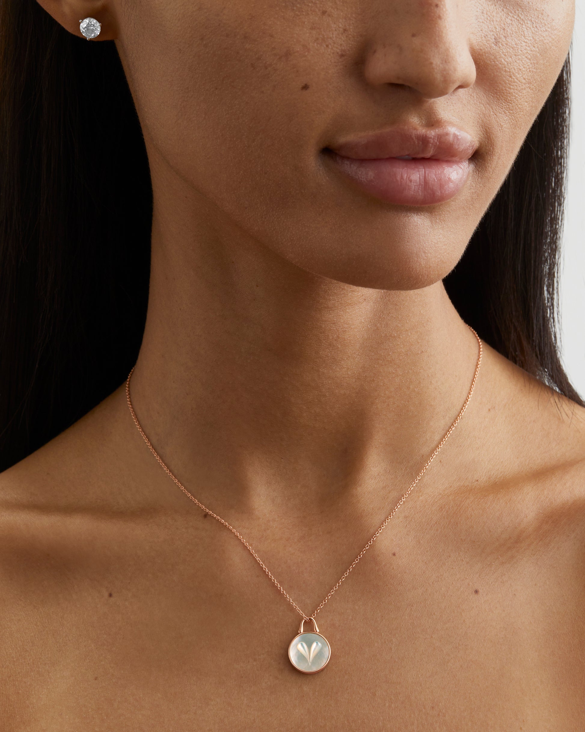 Roseate Cameo 12mm heart pendant in 18k rose gold with mother-of-pearl worn on a model