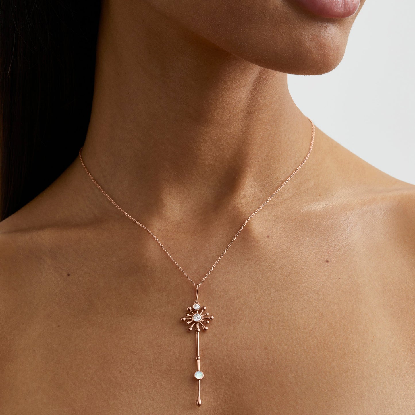 Roseate Light Wand pendant in 18k rose gold with mother-of-pearl worn on a model