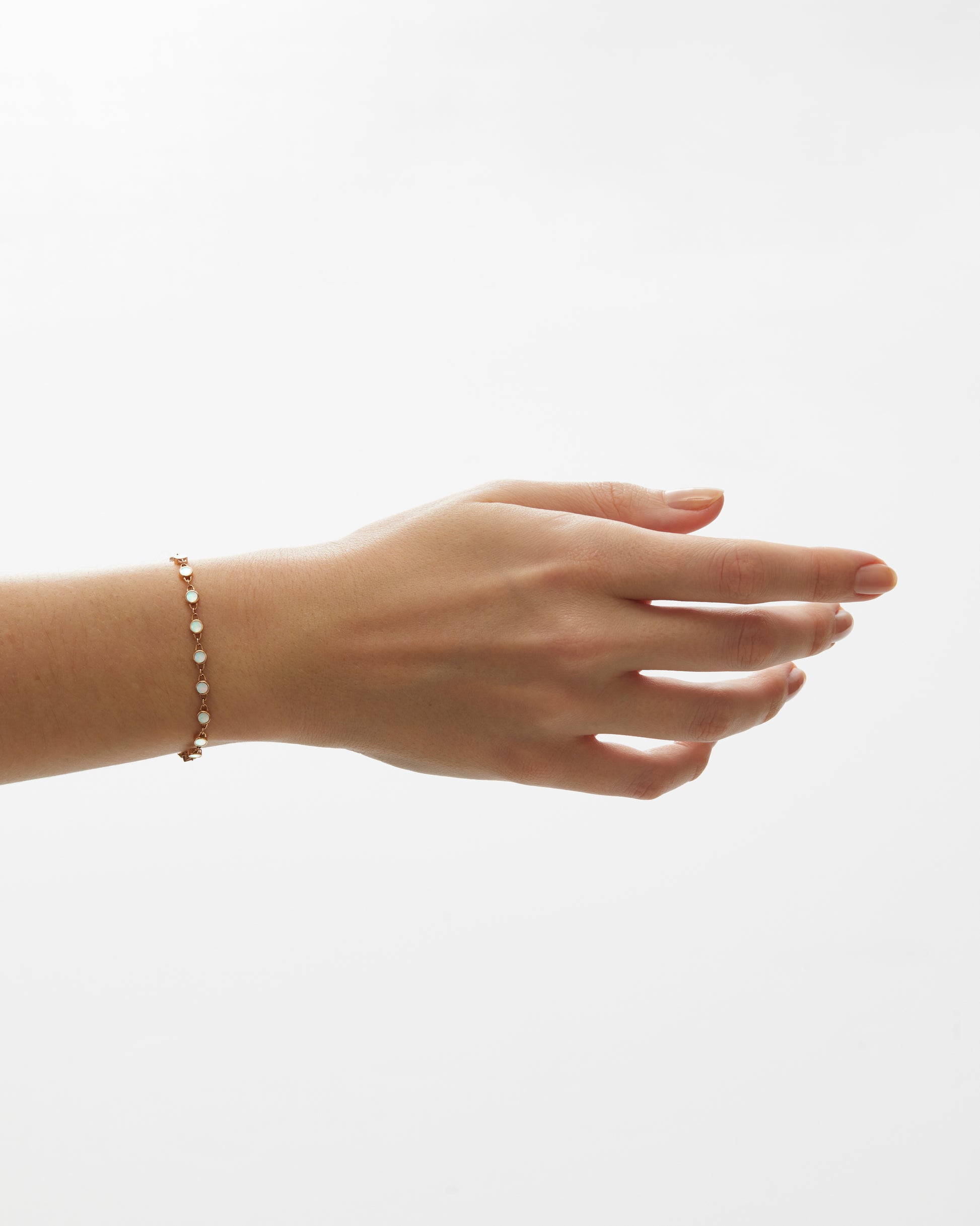 Roseate TreasureLock 3mm mother-of-pearl disc bracelet in 18k rose gold worn on a model