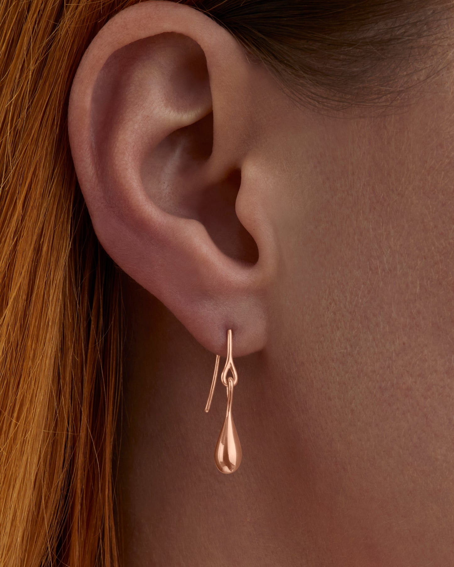 Roseate WaterDrop small earrings in 14k rose gold with mother-of-pearl worn on a model