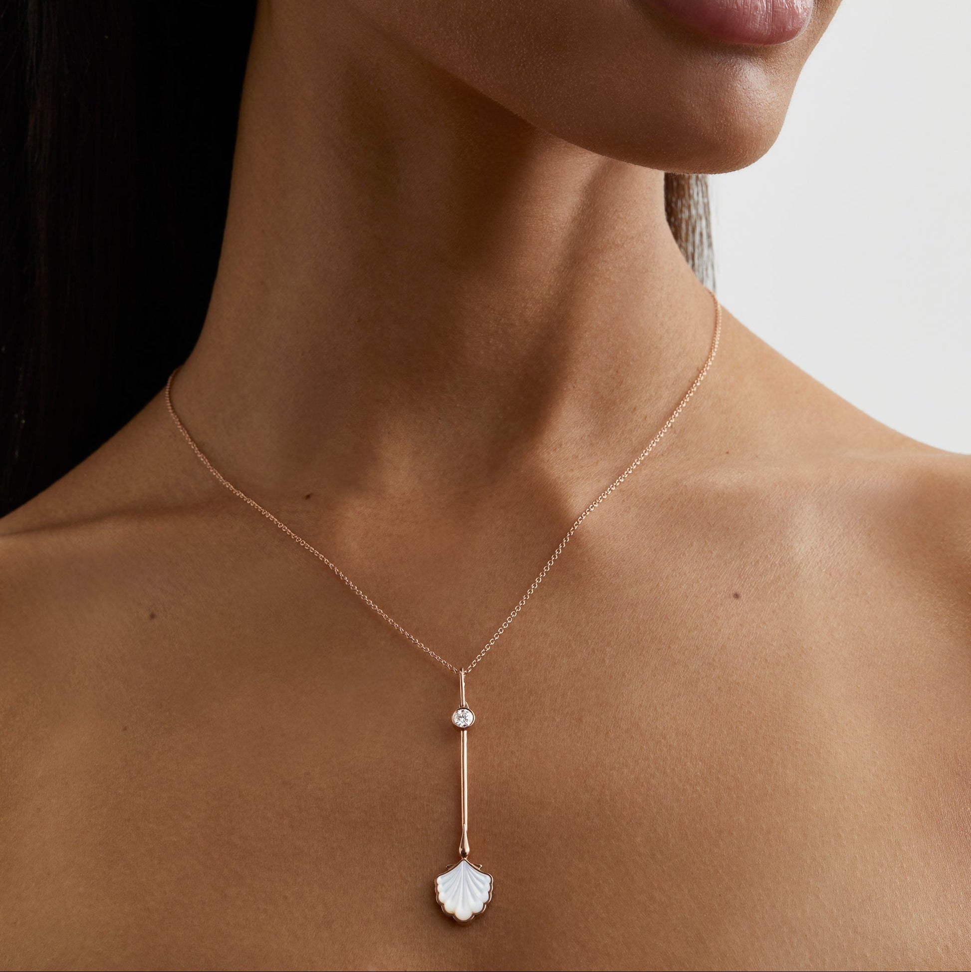 Water Wand Pendant in 18K rose gold with luminous mother-of-pearl worn on a chain